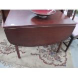 A drop leaf mahogany effect dining table