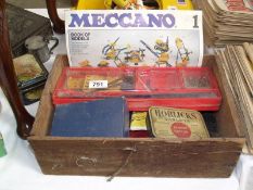 A wooden box of old meccano.