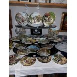Approximately 36 Doulton and Wedgwood plates including Cries of London, Country Days etc.