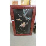 An oriental framed panel with abalone overlaid birds and foliage, 59 x 34 cm.