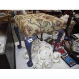 A tapestry covered stool with painted legs on ball and claw feet.