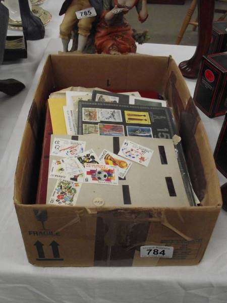 A box of stamp albums and loose stamps.