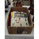 A box of stamp albums and loose stamps.