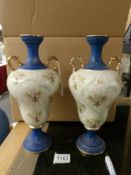 A pair of two handled Staffordshire vases.