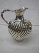 A mid 19th century silver jug with later engraving (1917) 18cm tall, approximately 465 grams.