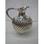 A mid 19th century silver jug with later engraving (1917) 18cm tall, approximately 465 grams.