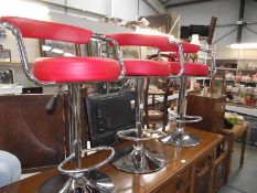 3 red leather and chrome bar stools.