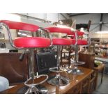 3 red leather and chrome bar stools.