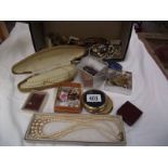 A mixed lot of costume jewellery including nursing buckle, R.A.F brooches etc.
