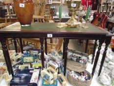 A dark wood stained long nest of table with leather inset tops (collect only).