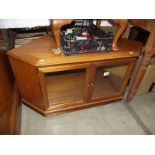 A dark wood corner TV stand with glazed doors. (collect only).