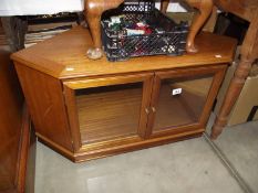 A dark wood corner TV stand with glazed doors. (collect only).