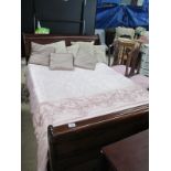 A mahogany sleigh bed with mattress an cushions