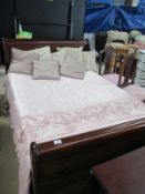 A mahogany sleigh bed with mattress an cushions