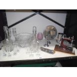 A quantity of glass decanters, silver backed brush, sewing machine etc.