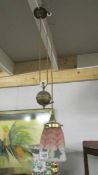 An Edwardian brass rise and fall ceiling light with shade.