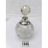 A glass scent bottle with silver rim and glass stopper.
