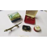 A Bilston enamel pill box, A Stratton pill box, one other, a pair of cuff links and a brass dog.