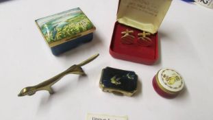 A Bilston enamel pill box, A Stratton pill box, one other, a pair of cuff links and a brass dog.