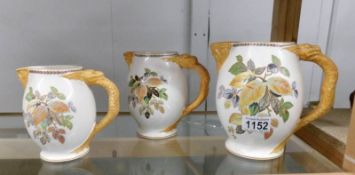 A set of 3 Losel Ware graduated jugs with dragon handles.