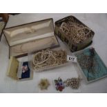 A quantity of faux pearl necklaces, several hat pins and vintage brooches.