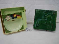 A late 18th century green glazed tile of military figure on horseback and a Carlton ware dish with