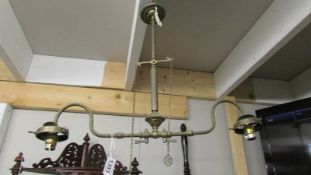 A Victorian brass gas double ceiling light with on/off tags, converted to electric.