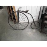 A vintage metal blacksmith model of a penny farthing bike.