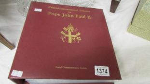 An album of commemorative covers featuring stamp tributes of Pope John Paul II with official first