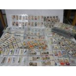 A large quantity of sleeves of cigarette and trade cards including some complete sets.