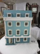A four storey dolls house and very good collection of dolls house furniture. (collect only).