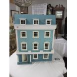 A four storey dolls house and very good collection of dolls house furniture. (collect only).