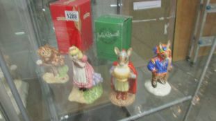 2 Royal Doulton and 2 Beswick figures including Alice in Wonderland and the Cheshire cat.