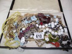 Approximately 20 necklaces and 4 bracelets.