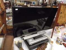 A Samsung LED TV monitor with DVD player and digital TV recorder.