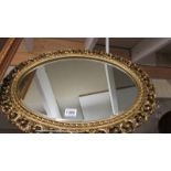 A oval gilt framed mirror, 49 x 33 cm.