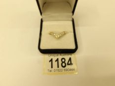 An 18ct yellow gold and diamond wishbone ring, size L half.