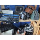 Two shelves of electrical equipment including an audio mixer,
