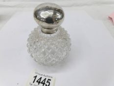 A scent bottle with silver hinged lid,