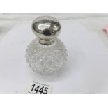 A scent bottle with silver hinged lid,