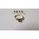 A peridot gem stone ring with diamond shoulders in 9ct gold, size N,