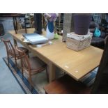 A large extending oak modern dining table