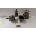 A silver plate 3 piece condiment set with blue glass liners and a brass bell.