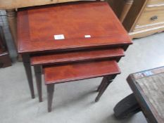 A nest of mahogany tables