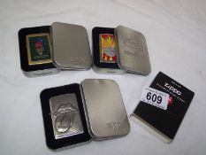 Three Zippo lighters in cases - Atlanta 96, Rolling Stones and Harley Davidson.