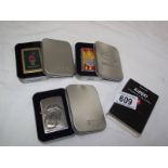 Three Zippo lighters in cases - Atlanta 96, Rolling Stones and Harley Davidson.