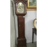 A small oak cased long case clock with brass dial.