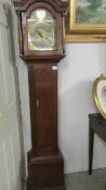 A small oak cased long case clock with brass dial.