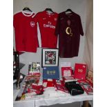 A collection of Arsenal memorabilia including team shirt, signed shirt,