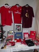 A collection of Arsenal memorabilia including team shirt, signed shirt,